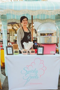 a woman standing in front of a tent