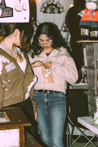 a woman is looking at a teddy bear